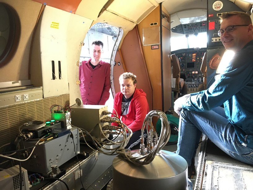 SRON engineers  Rob Wolfs (left), Jens Johansen (middle) and Geert Keizer (right) inside the Falcon aircraft during the installation of SPEX airborne. In the front the aluminum dome holding SPEX airborne and electronics boxes